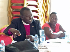 Bishop Eitu demonstrates a homemade mosquito trap (inverted bottle technique!)